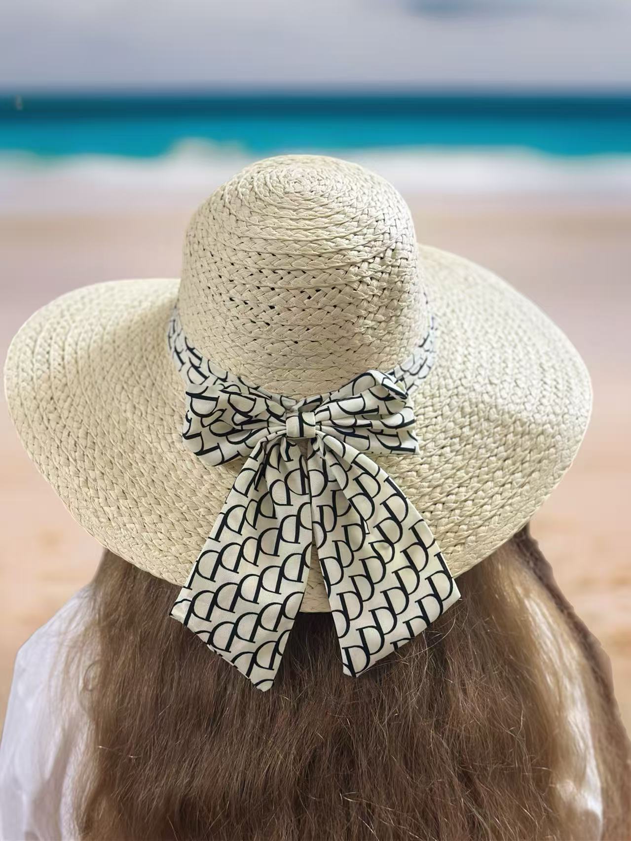 Beige Woven Straw Hat with Patterned Bow