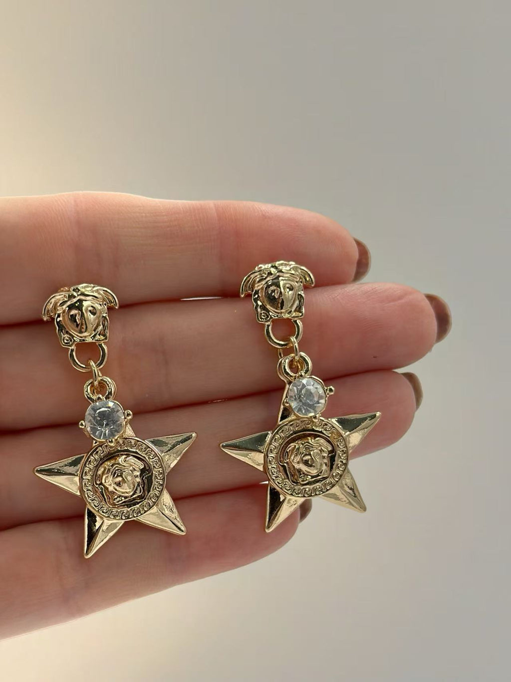 Bold Star Drop Earrings with Crystal and Medusa Motif