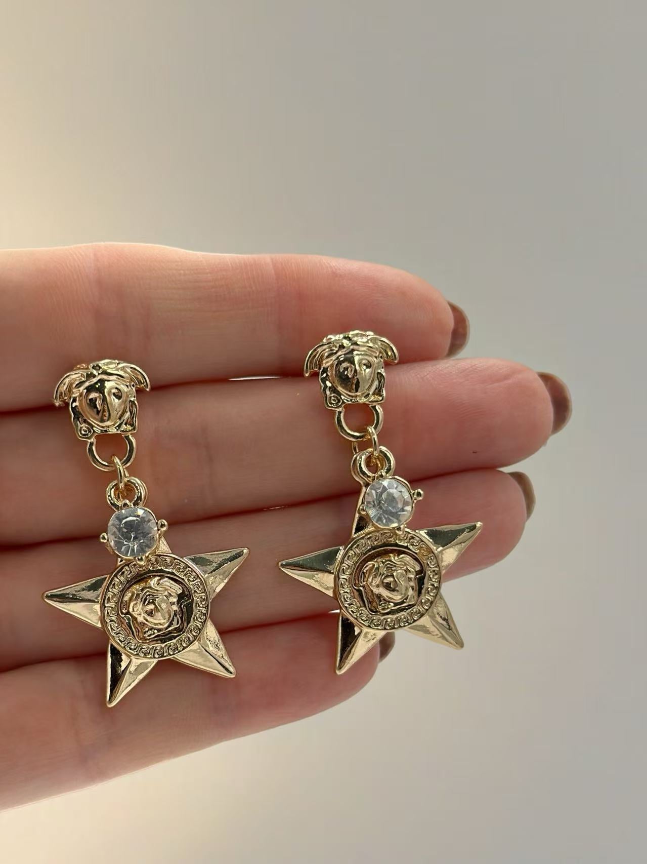 Bold Star Drop Earrings with Crystal and Medusa Motif