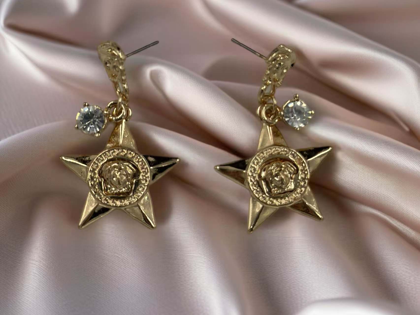 Bold Star Drop Earrings with Crystal and Medusa Motif